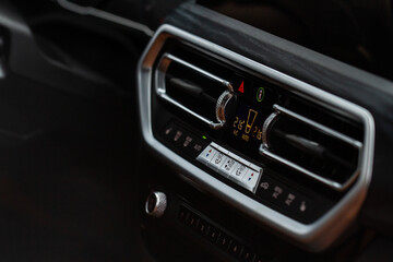 Digital control panel car air conditioner dashboard. Modern car interior conditioning buttons inside a car close up view.