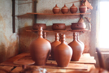 Fototapeta na wymiar Pottery, ceramic and handmade products on a shelf in a workshop and showroom