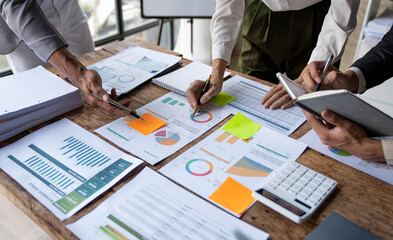 Asian business colleagues meeting to analyze financial reporting situation Investment and accounting concept sitting table and pointing at document. Profit chart. Graph showing growth.