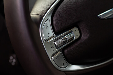 Obraz premium Call buttons on car steering wheel. Audio control buttons on the steering wheel of a modern car.