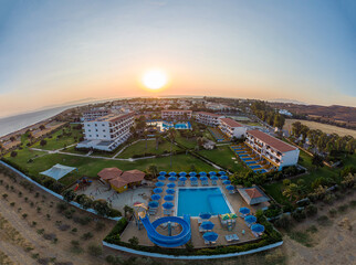 Sunrise behind the hotel with swimming pool