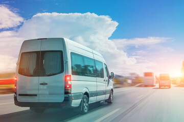 Passenger white bus van accelerating ride motion blur effect.