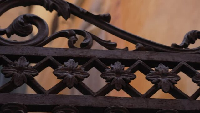 Traditional beautiful Western gate with ornamentation and iron decoration. Floral decorative pattern forged made from metal. Vintage concept