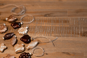 Christmas tree decorations in natural colors lie on a beautiful wooden table