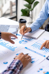 Asian business ideas are thinking and calculating with a calculator. front view of hand pointing to business data chart to calculate analysis Company financial processing.