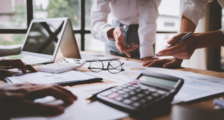 business people meeting in the office Calculate the tax and income of the company's investment. Strategic Planning and Brainstorming colleague concept, report, analyze graph plans