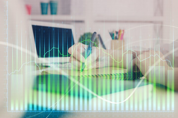 Financial graph displayed on woman's hand taking notes background. Concept of research. Double exposure