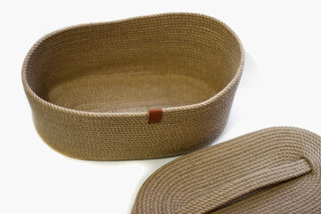 Wicker basket with jute lid on white isolated background