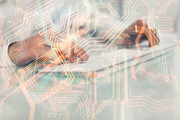 Technology theme hologram with man working on computer on background. High tech concept. Multi exposure.
