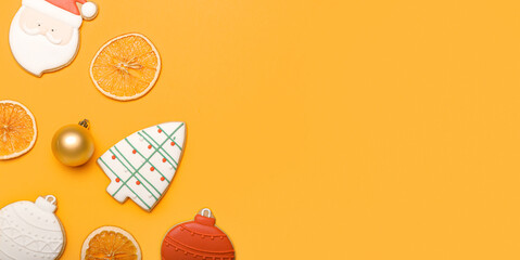 Beautiful Christmas cookies, dry orange slices and decor on color background with space for text