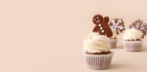 Tasty Christmas cupcake with gingerbread cookie on beige background with space for text