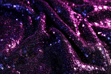 Purple fabric with sequins as background