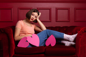 Women on couch with three heart shapes in front of her