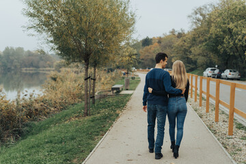 Young cheerful couple walking in a park