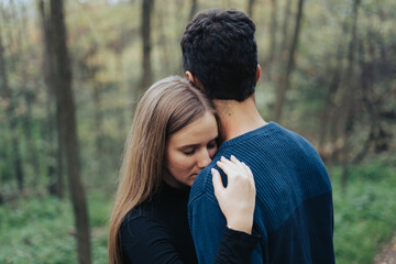 Hugging couple in a forest