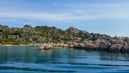 Naklejka premium view of the ancient cliffs from the sea. Sea and beach view on a summer day. Kekova, Antalya, Turkey