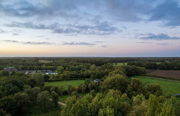 Fototapeta na wymiar Aerial view of green fields and countryside at sunset. Aerial landscape photo. Gronau, Germany
