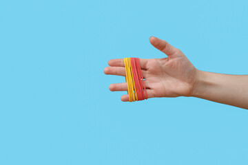 Woman with rubber bands on blue background