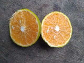 Sliced of orange fruits on the wooden table
