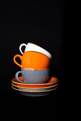 colorful porcelain coffee cups on a black background.