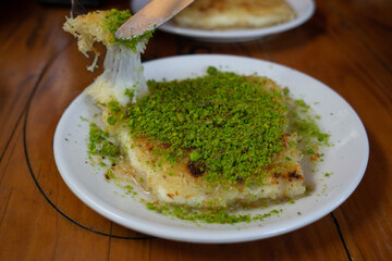Serving Kunefe with pistachio