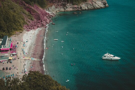 Aerial view of the coast and the boat in the sea in Babbacombe, Torquay, Devon UK