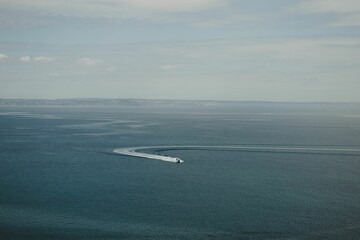 Obraz premium Aerial view of the coast and the boat in the sea in Babbacombe, Torquay, Devon UK