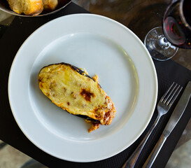Worldwide popular dish is stuffed eggplant, with cheese baked on top. Close-up image