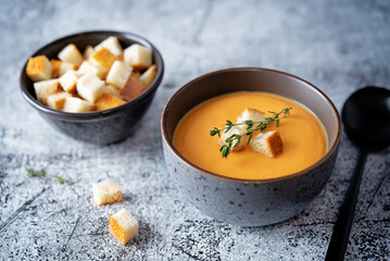 Sweet potato soup with croutons and thyme leaves - obrazy, fototapety, plakaty