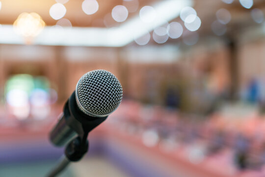 Public Microphone for speech speaking in seminar hall on blure backgrounds, Close-up  microphones on stand for speaker teaching room with Event light convention hall for Business meeting education