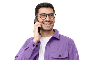 Cheerful young man in purple shirt and glasses, talking on the phone and laughing to joke