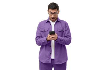 Surprised young man in purple shirt looking at his smartphone with amazed facial expression, shocked by new online app