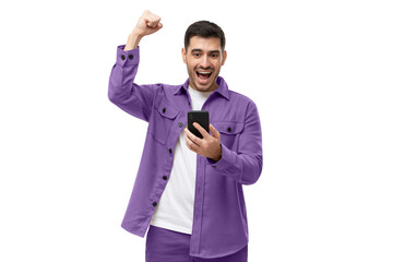 Happy excited sucessful modern man holding phone and raising arm up to celebrate achievement - obrazy, fototapety, plakaty