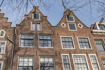Fototapeta premium Old building (XVII- XVIII centuries) with gable rooftop and hook Amsterdam’s Kattenburg. Kattenburg is Island in Amsterdam that were built in second half of XVII century. Amsterdam, the Netherlands.