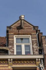 Old building (XVII- XVIII centuries) with gable rooftop and hook Amsterdam’s Kattenburg. Kattenburg is Island in Amsterdam that were built in second half of XVII century. Amsterdam, the Netherlands.