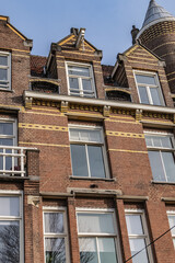 Obraz premium Old building (XVII- XVIII centuries) with gable rooftop and hook Amsterdam’s Kattenburg. Kattenburg is Island in Amsterdam that were built in second half of XVII century. Amsterdam, the Netherlands.