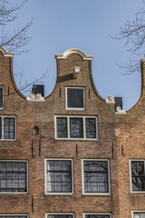 Old building (XVII- XVIII centuries) with gable rooftop and hook Amsterdam’s Kattenburg. Kattenburg is Island in Amsterdam that were built in second half of XVII century. Amsterdam, the Netherlands.