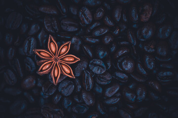 Star anise isolated on a background full of arabica coffee beans. - obrazy, fototapety, plakaty