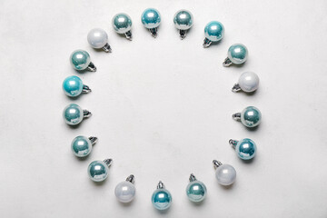 Frame made of beautiful Christmas balls on light background