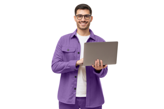 Young man standing in casual purple shirt, holding laptop and looking at camera with happy smile