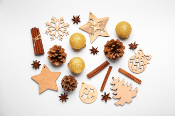 Composition with Christmas decorations, spices and cones on light background