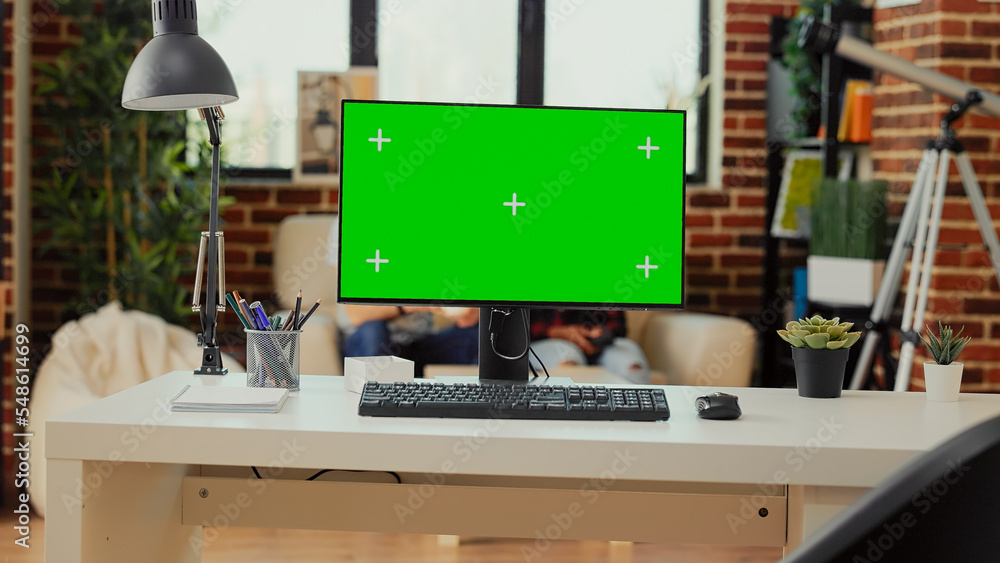 Aufkleber empty office desk with greenscreen display on computer used to work on freelance in living room work