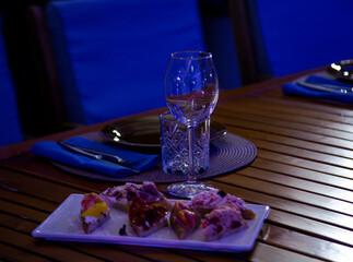 Delicious, beautiful slicing,appetizer on the table in a restaurant, in neon lighting