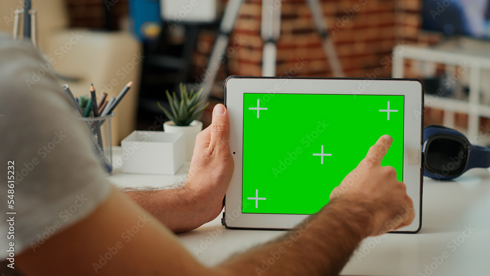 Poster young adult analyzing horizontal greenscreen on digital tablet with isolated chroma key display at h
