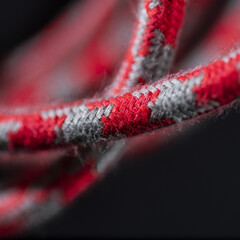 Red and Grey Braided Cable on Black Background