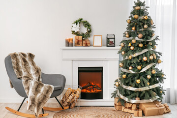 Interior of living room with fireplace, Christmas tree and armchair