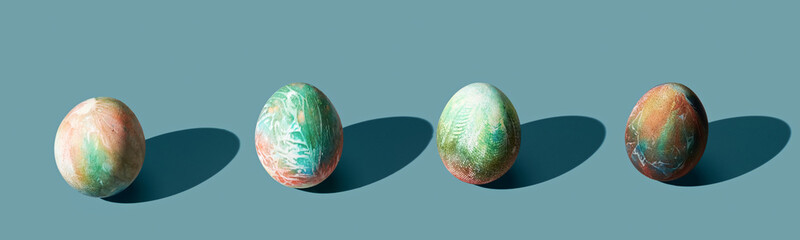 Different easter eggs on blue pastel background