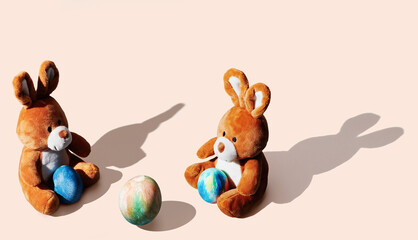 soft toy bunny with easter egg on orange pastel background