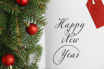 Greeting card, fir branches and Christmas balls, closeup