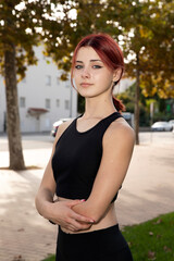 Portrait of a beautiful sports model girl with red hair.
